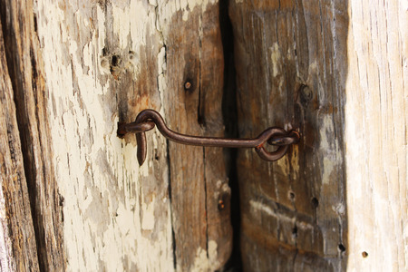 Old latch with hook on a wooden doorの写真素材