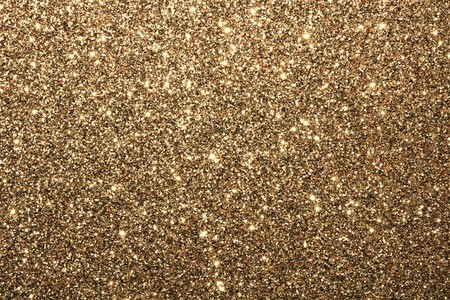 Sparkling gold glitter background with room for text.の写真素材