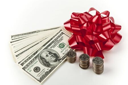 Holiday cash money with red bow centered on white backgroundの写真素材