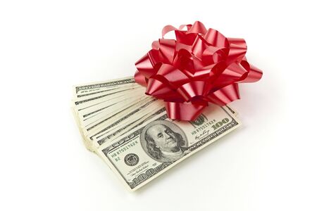 holiday gift money with red bow on white backgroundの写真素材