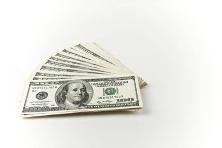 stack of low profile hundred dollar bills left side on white backgroundの写真素材