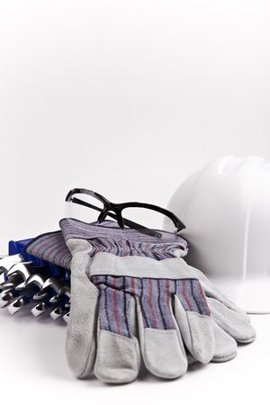 vertical close up hard hat leather gloves safety glasses wrenchesの写真素材