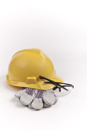 yellow hard hat safety glasses and leather glovesの写真素材