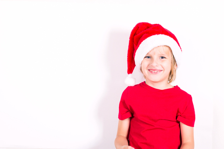 Happy boy in Santa red hat. Christmas concept.の写真素材