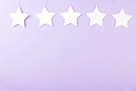White star, purple background, party decor. Top view. Copy spaceの写真素材