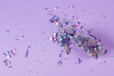 Sprinkles grainy. Sweet confetti. Purple background for holiday designs, party, birthday, wedding invitationの写真素材