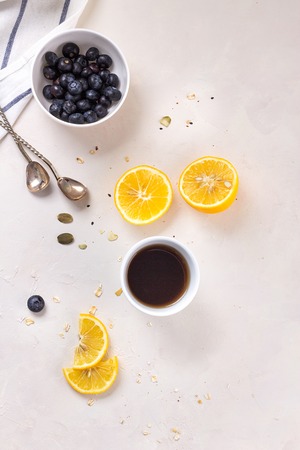 Happy morning breakfast healthy food concept on white background tea with lemon and blueberry. Flatlayの写真素材