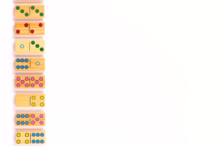 Colored domino pieces on white background. Celebration,party, kids, educational background. Flat lay. Copy spaceの写真素材