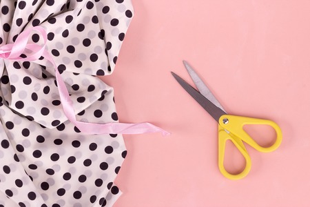 Flat layout with frame for text. Sewing tools, scissors, colored threads, needles, pins, measuring tape, coils, buttons. Fashion concept, studio, tailoring. Copy space. Flat layの写真素材