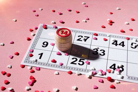 Lotto ticket with wood barrel 14 number on pink hearts background. Valentines day 14 february...