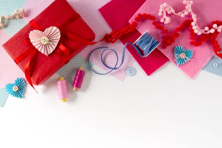 Valentines day and 14 february holidays banner. Gift wrapping workspace. Decoration presents making flat lay top view celebration preparation DIY concept decor on white backgroundの写真素材
