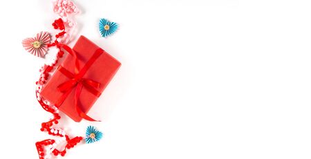 Red gift box with heart and bow on white background. Valentines day 14 february packaging concept. Flat lay, copy space, top view. Wide bannerの写真素材