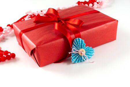 Red gift box with heart and bow on white background. Valentines day 14 february packaging conceptの写真素材