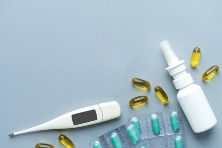 Flat lay healthcare medical accessories and pills on blueの写真素材