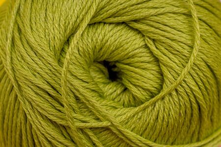 Yarn for knitting close-up green background