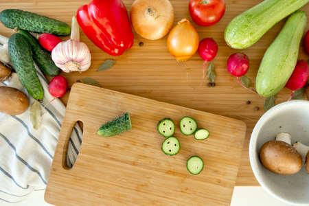 Healthy nutrition salad preparing concept. Various vegetables on the kitchen table.の写真素材