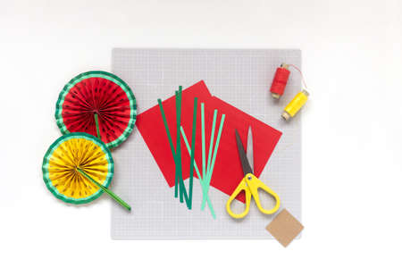 DIY instruction. Step by step tutorial. Making decor for summer birthday party - red and yellow watermelon fan. Craft tools and supplies. Step 2の写真素材