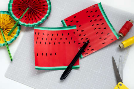 DIY instruction. Step by step tutorial. Making decor for summer birthday party - red and yellow watermelon fan. Craft tools and supplies. Step 4の写真素材