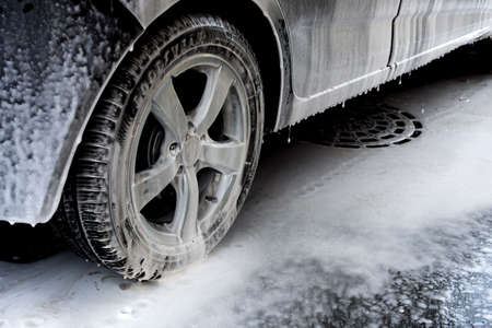 Car washing. Cleaning car using high pressure water. Contactless self-service car wash. Concept disinfection and antiseptic cleaning of the vehicle. Russia, Rostov-on-Don 06.12.2020の写真素材