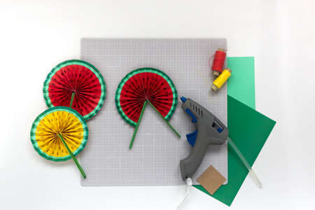 DIY instruction. Step by step tutorial. Making decor for summer birthday party - red and yellow watermelon fan. Craft tools and supplies. Step 8 -Finalの写真素材