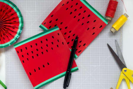 DIY instruction. Step by step tutorial. Making decor for summer birthday party - red and yellow watermelon fan. Craft tools and supplies. Step 4の写真素材