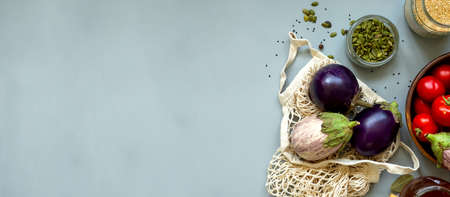 Healthy food vegetables on grey background. Groceries in recycle textile bags. Eco friendly plastic...