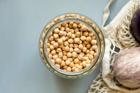 Close-up chickpeas flat lay. Organic bio products in zero waste shop. Foods storage kitchen low waste lifestyle. Cereals and grains in glass jars. Eco friendly shopping plastic free grocery store.の写真素材