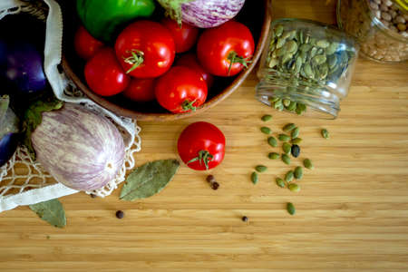 Zero waste healthy food-cereals, seeds, vegetables flat lay on grey background. Groceries in textile bags,glass jars, wooden bowl. Eco friendly plastic free low waste lifestyle.の写真素材