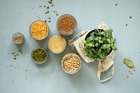 Organic bio bulk products in zero waste shop. Foods storage in kitchen at low waste lifestyle. Cereals and grains in glass jars on table. Eco friendly shopping in plastic free grocery store.の写真素材