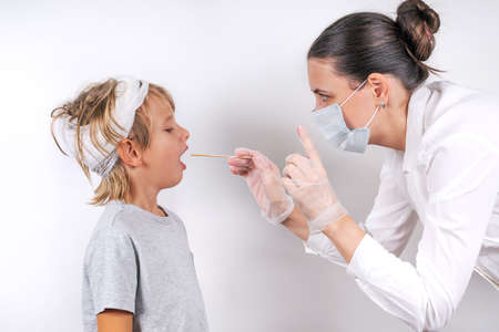 Medicine, healthcare and pediatry concept. A female doctor in medical mask and transparent gloves...