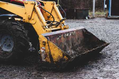 Excavator working with black soil and dustyの写真素材