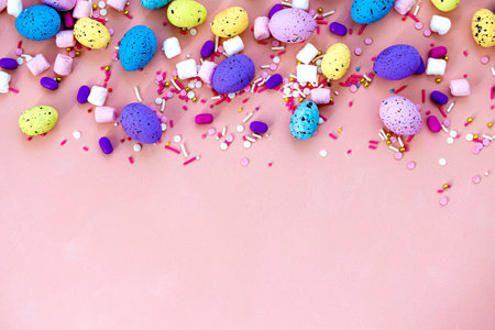 Top view shot of arrangement decoration Happy Easter holiday background concept. Flat lay colorful bunny eggs on beautiful pink desk. Copy space.の写真素材
