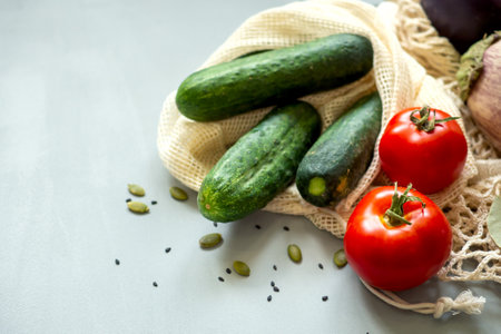 Zero waste healthy food-cereals, seeds, vegetables flat lay on grey background. Groceries in textile bags,glass jars, wooden bowl. Eco friendly plastic free low waste lifestyle.の写真素材