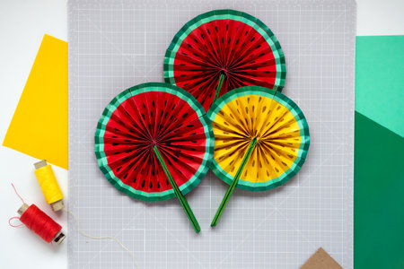 DIY instruction. Step by step tutorial. Making decor for summer birthday party - red and yellow watermelon fan. Craft tools and supplies. Step 8 - Finalの写真素材