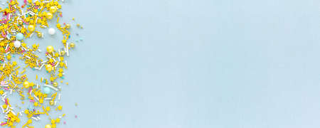 Wide banner with copy space Sugar sprinkles grainy background for holiday designs, party, birthday, wedding invitationの写真素材