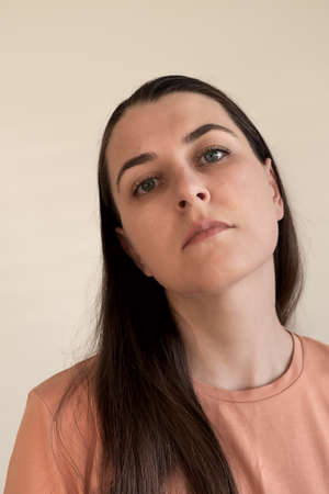 Emotional portrait of young caucasian brunette woman with natural makeupの写真素材