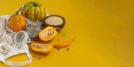 Zero waste healthy food pumpkin, seeds, vegetables, dried fruits flat lay on orange background. Groceries in textile bags,glass jars. Eco friendly plastic free low waste lifestyle.の写真素材