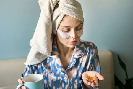 Woman with pill cod liver oil Omega-3 D-vitaminの写真素材