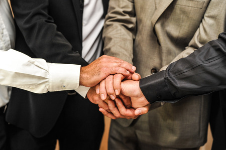 business team cross hands work togetherの写真素材