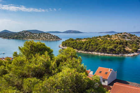 Small island in adriatic sea in summer. Red roofs clear cristal waterの写真素材