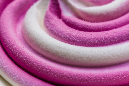 Swirling pink Italian ice cream with a ridged pattern background textureの写真素材