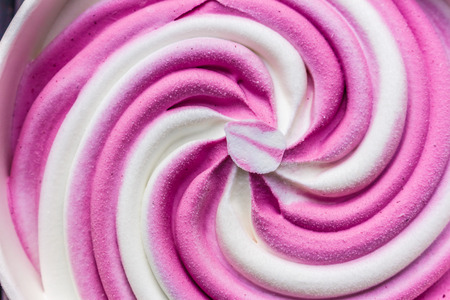 Swirling pink Italian ice cream with a ridged pattern background textureの写真素材