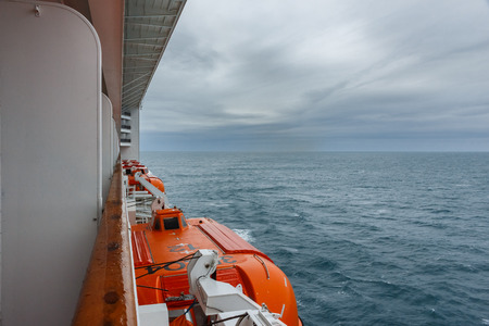 Safety lifeboat on deck of a cruise ship. Bad weather condition.の写真素材