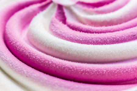Swirling pink Italian ice cream with a ridged pattern background textureの写真素材