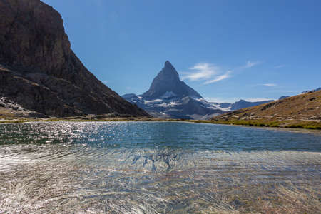 Matterhorn Mountain with white snow and blue sky in summer in Switzerlandの写真素材