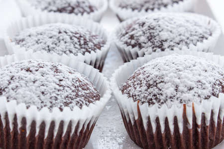 Several chocolate muffins on the white square plate. Shallow focus. Close upの写真素材