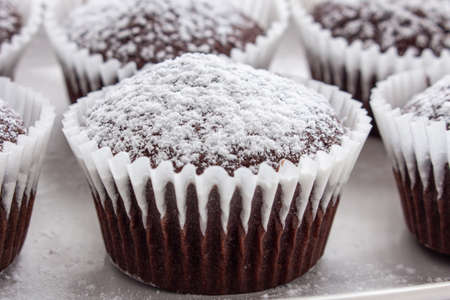 Several chocolate muffins on the white square plate. Shallow focus. Close upの写真素材