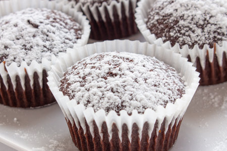 Several chocolate muffins on the white square plateの写真素材