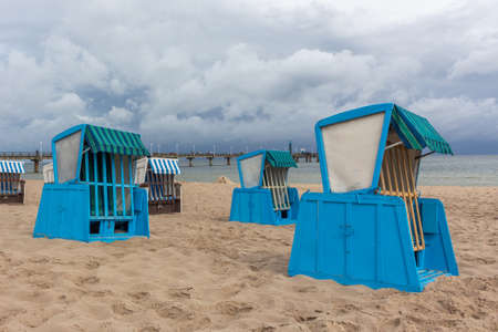 Lonely beach wooden wicker chairs on beach Baltic Sea, Germanyの写真素材
