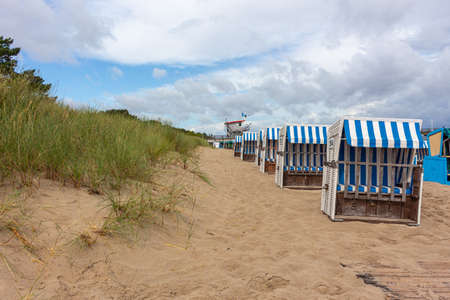 Lonely beach wooden wicker chairs on beach Baltic Sea, Germanyの写真素材